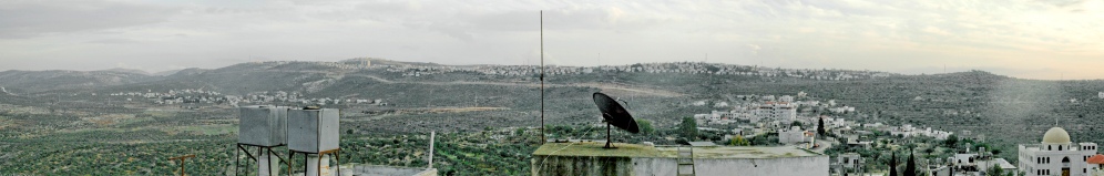 Water tower in Qira, Fareed's home village, Salfit district-in the background the huge Ariel illegal settlement, 2007 c.